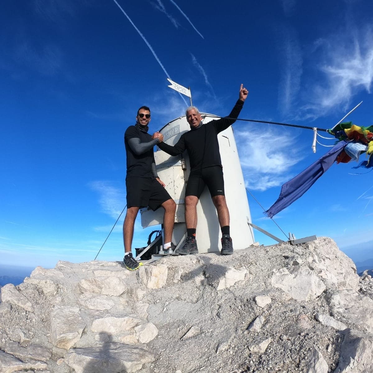 Two climbers at the summit of Triglav in the Julian Alps