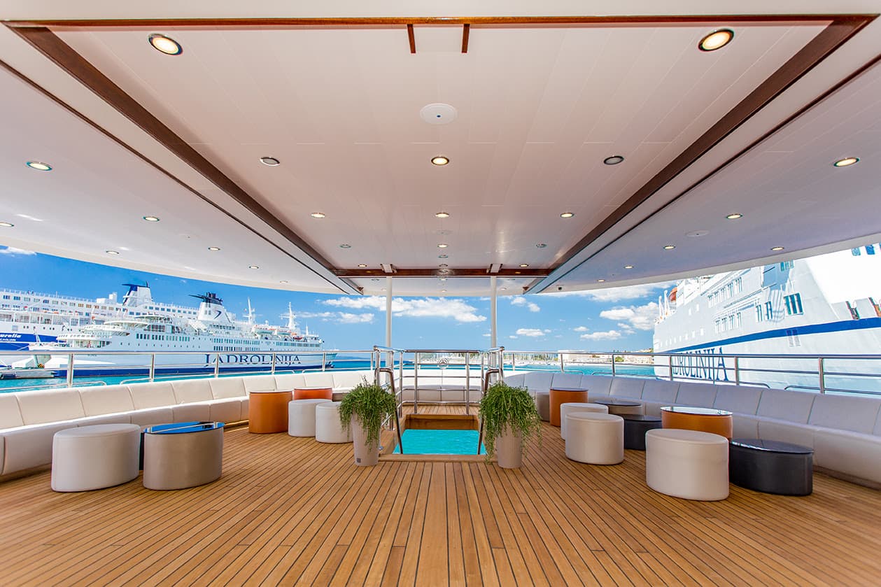 Sun deck lounge of a small cruise ship in a Croatian port