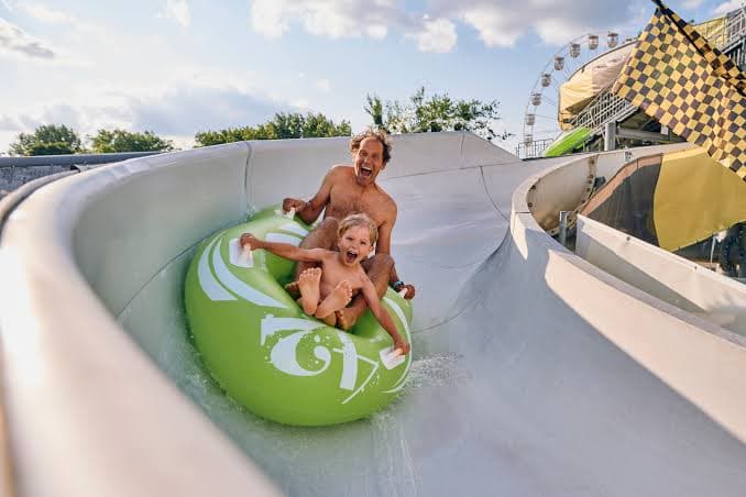 Father and child riding a water-park slide