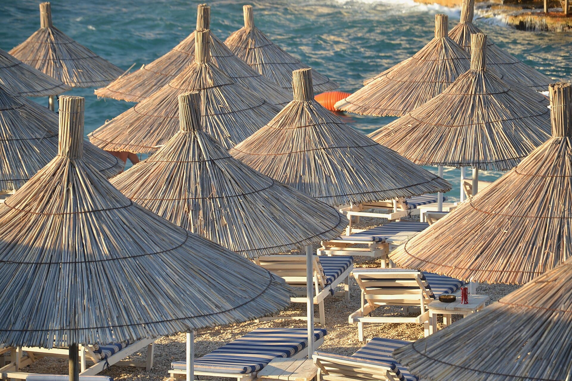 Straw umbrellas on a Ksamil beach, Albanian Riviera