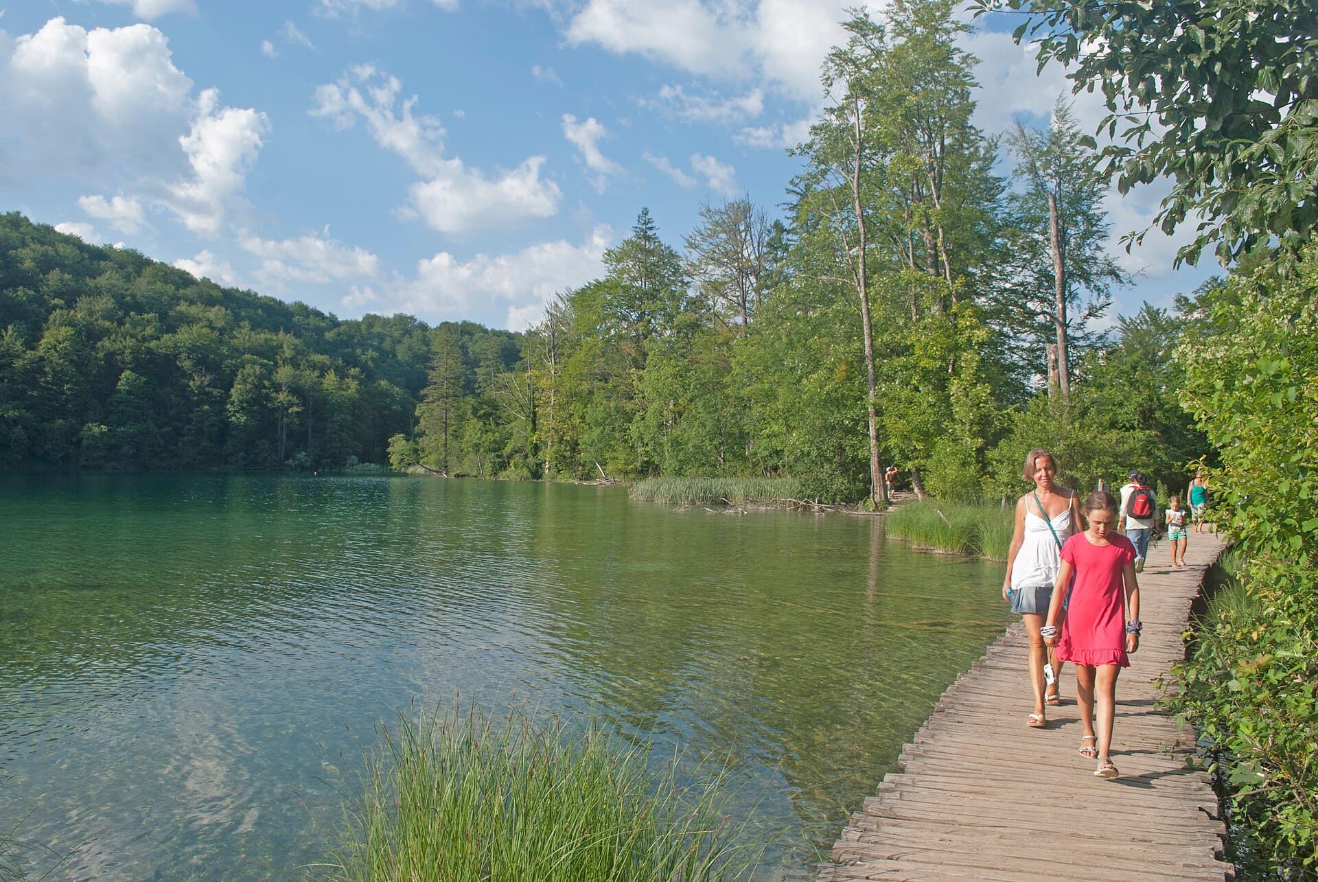 Boardwalk along a turquoise lake in Plitvice