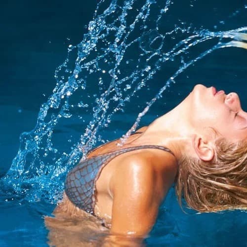 Woman relaxing in water at a thermal spa